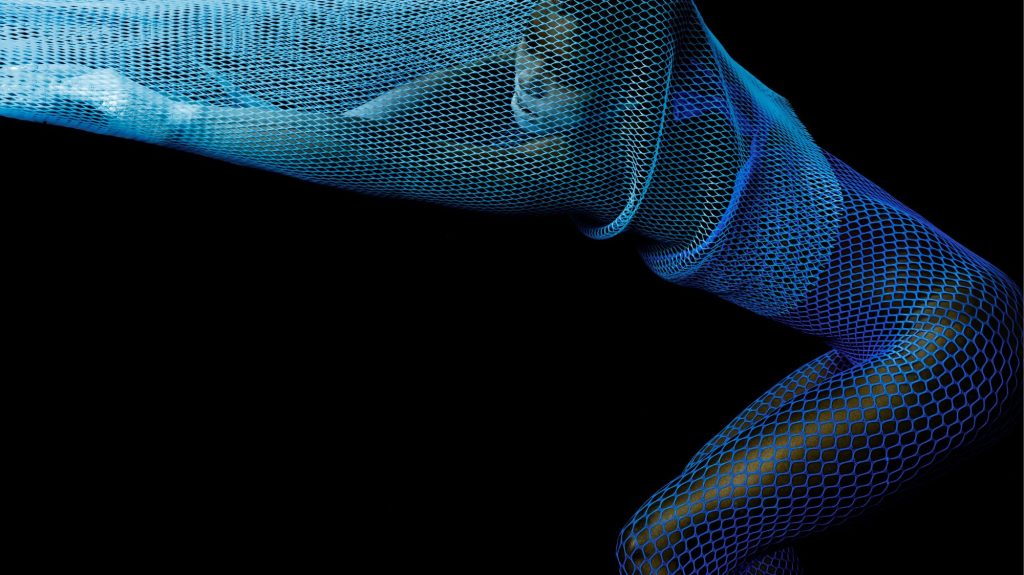 Figure enveloped in blue mesh material, forming fluid lines and geometric textures against a black background — symbolizing transformation, digital identity, and futuristic aesthetics.