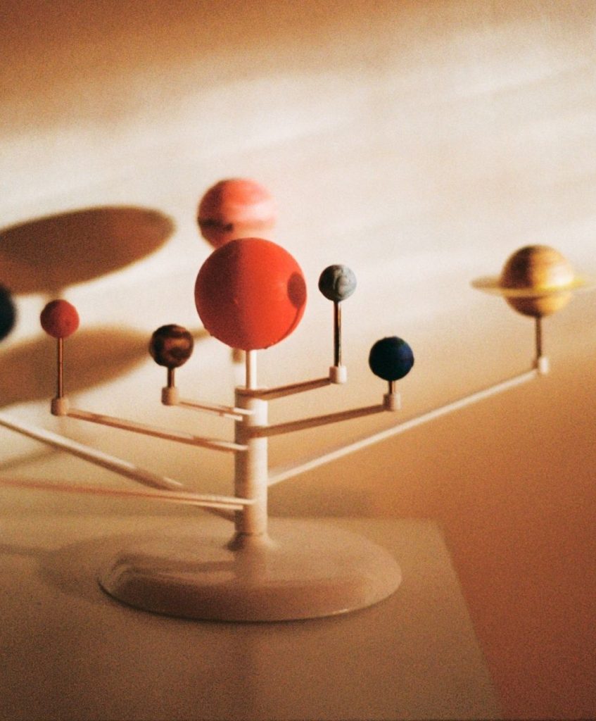 Solar system model with soft shadows, symbolizing regenerative systems in C2 Fashion Studio’s trend forecasting.