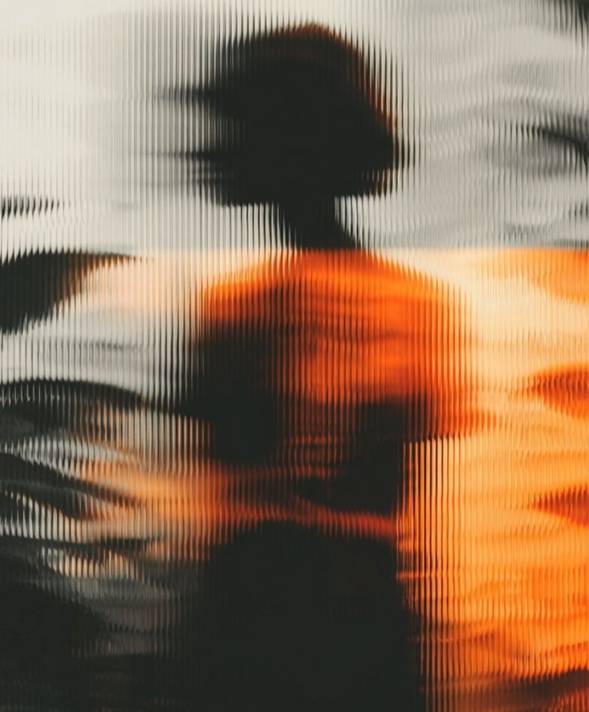 Abstract blurred silhouette through textured glass in warm orange tones — visual metaphor for emotional sustainability and regenerative design.
