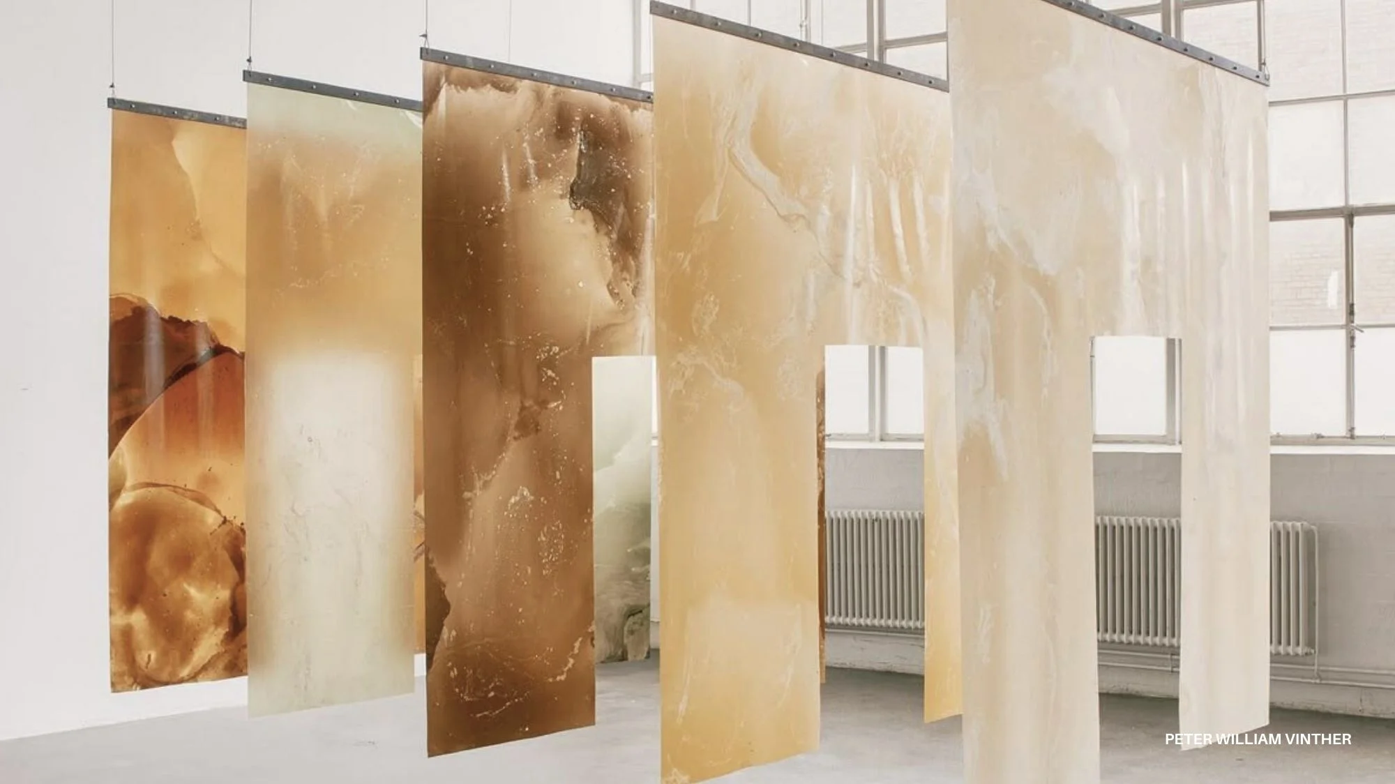 Sculptural translucent panels in warm earthy tones by Peter William Vinther, symbolizing Resonant Grounding for Autumn Winter 2027/2028, decoded by C2 Fashion Studio’s trend forecasting platform.