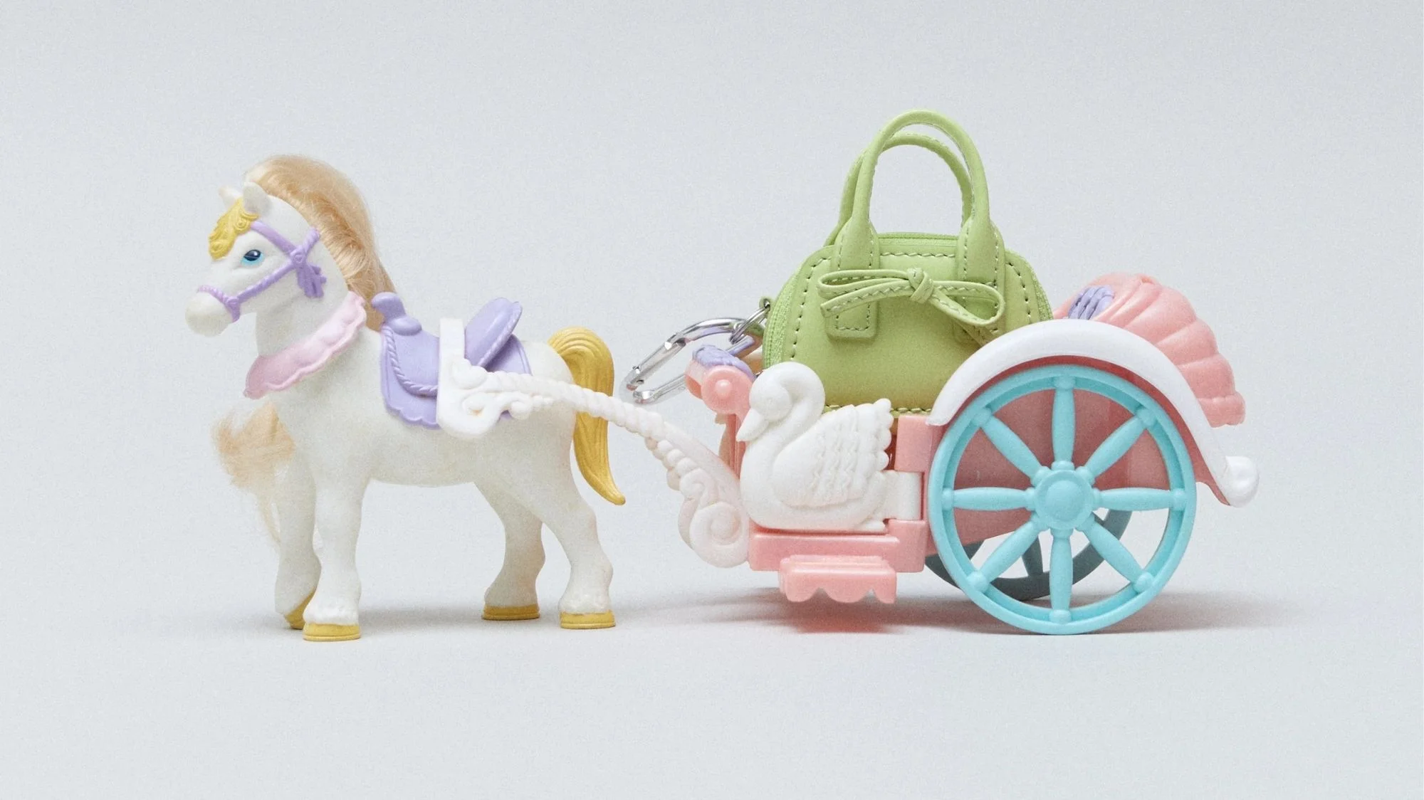 Toy horse and pastel carriage with mini handbag, symbolizing childhood fantasy in Sandy Liang’s Spring Summer 2026, highlighted by C2 Fashion Studio trend forecasting agency.