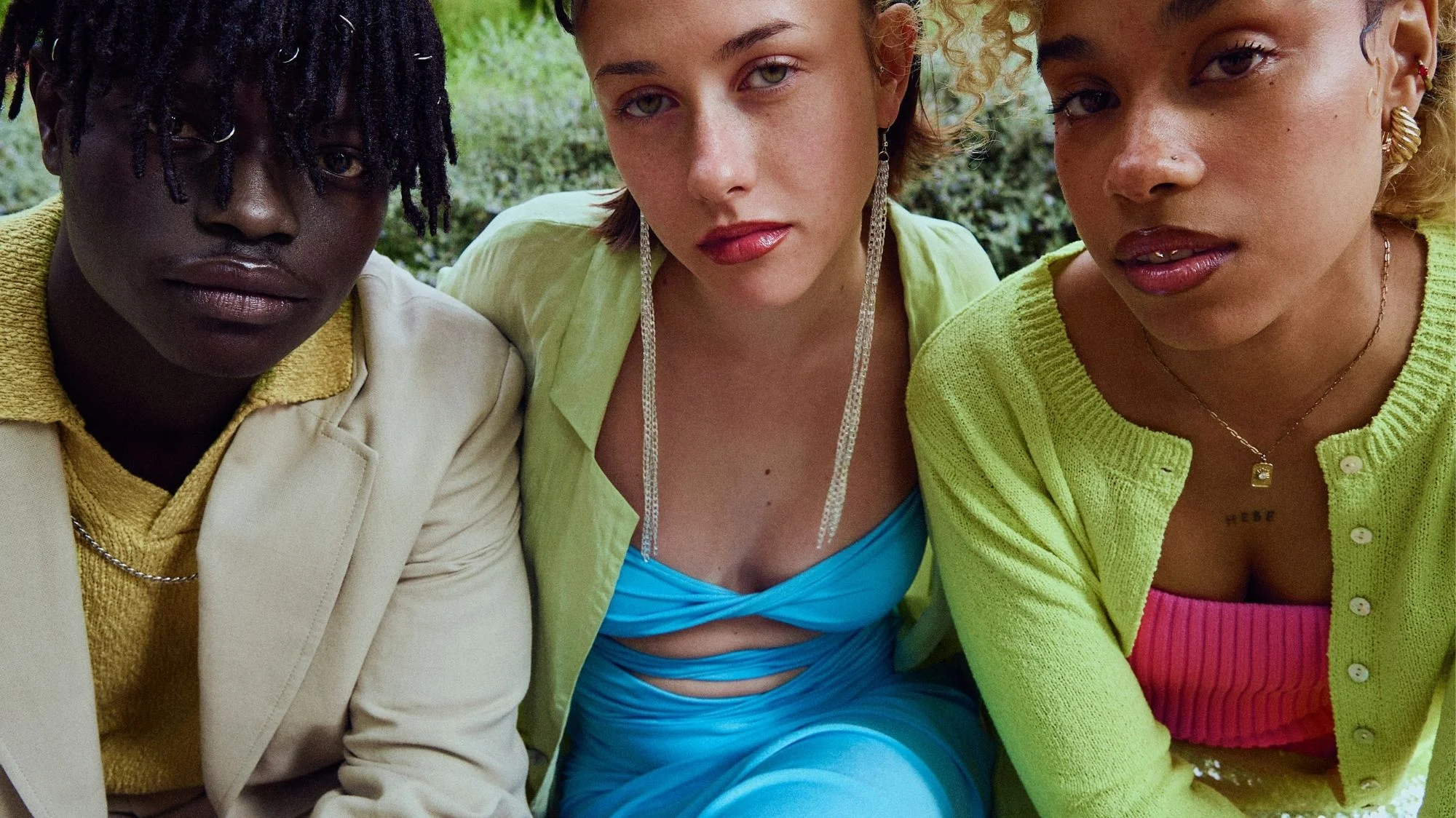Three models in bold, colorful outfits and contemporary styling, representing fragmented aesthetics and cultural acceleration. Curated by C2 Fashion Studio, a leading trend forecasting agency specializing in fashion trend forecasting.