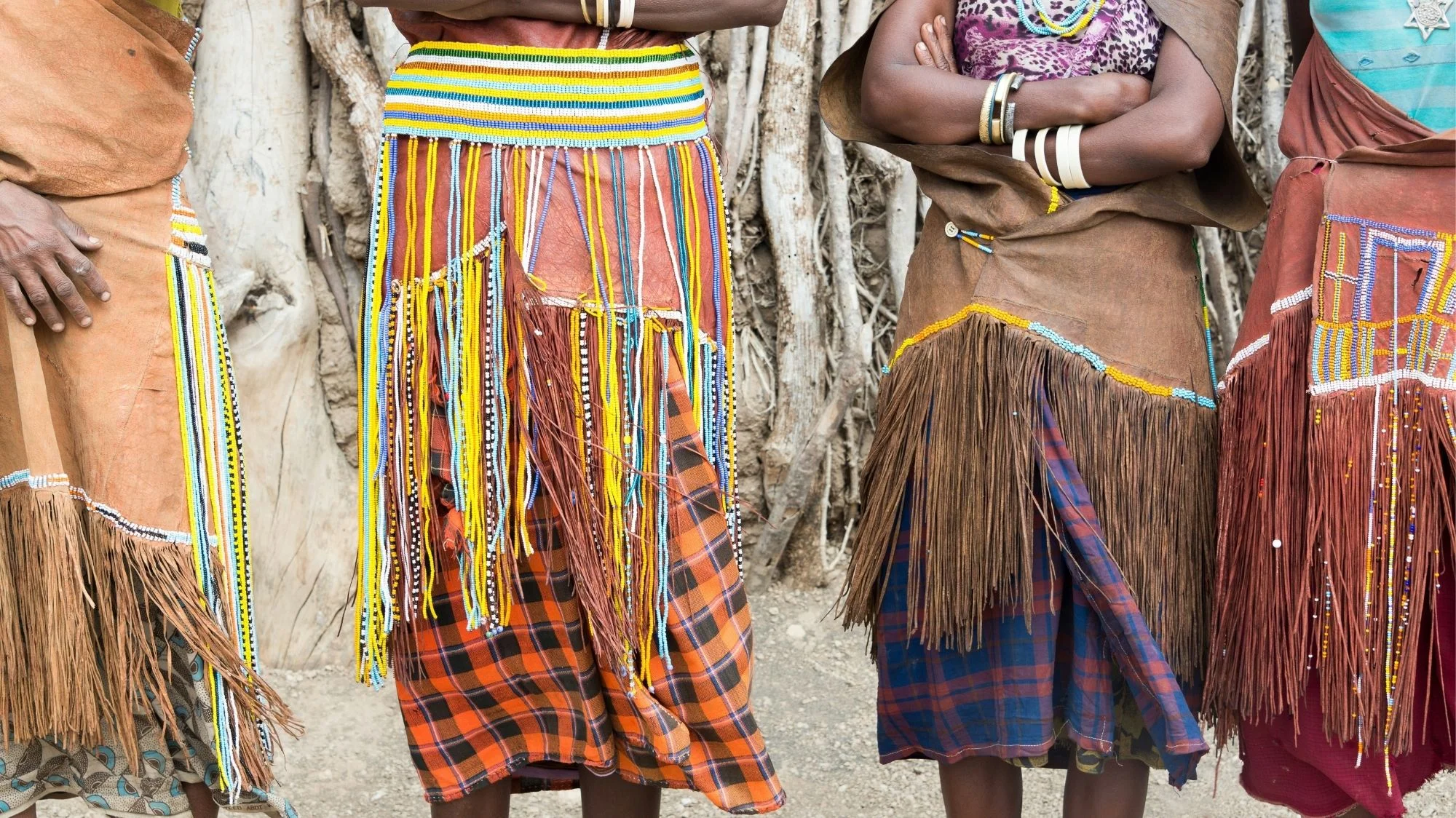 Traditional skirts with colorful beads, fringes, and woven textiles, showcasing cultural craftsmanship and heritage within a fashion trend highlighted by C2 Fashion Studio, a leading trend forecasting agency.