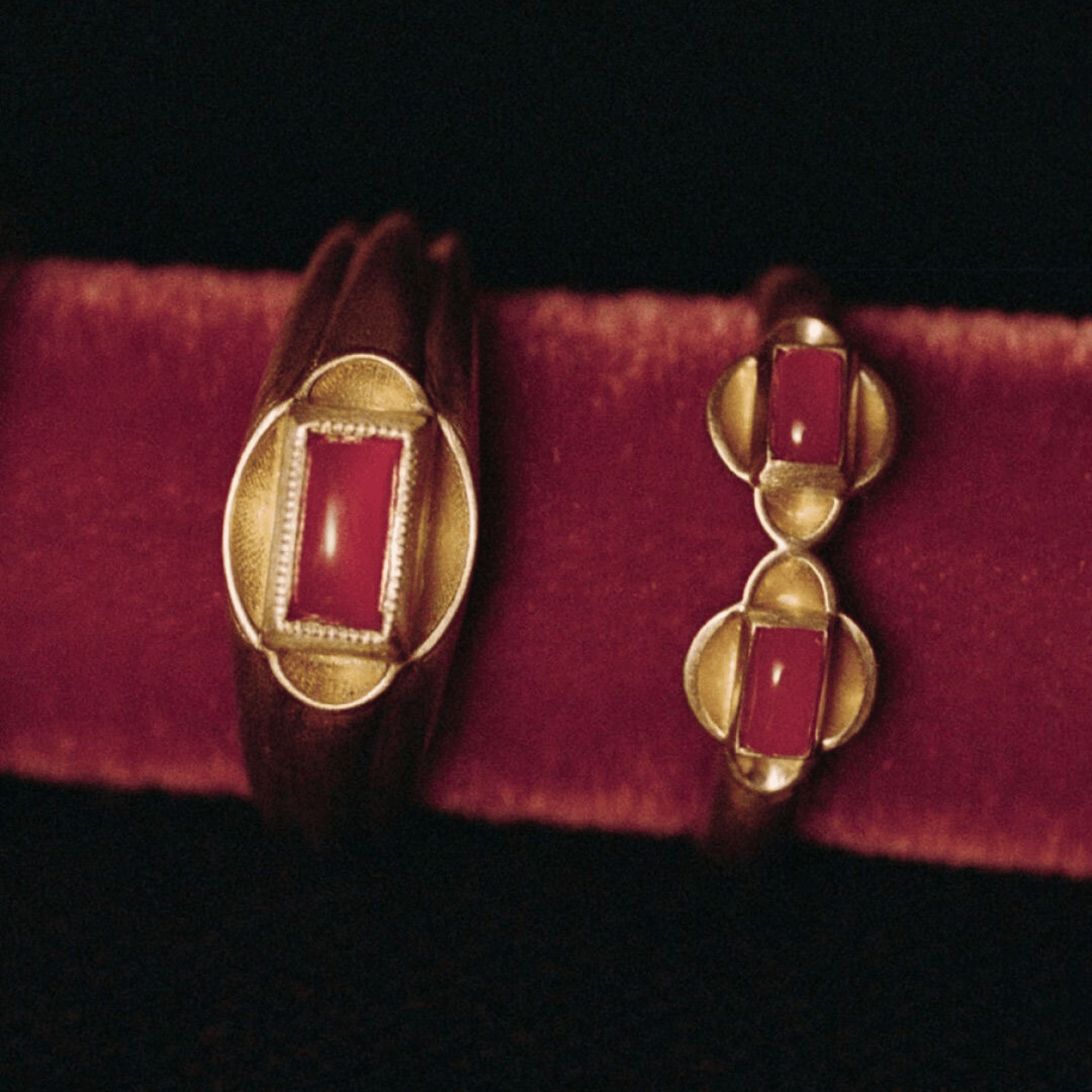 Close-up of vintage-inspired gold rings with deep red gemstones on velvet, representing Autumn Winter 2027 2028 jewelry trends and luxury fashion forecasting.