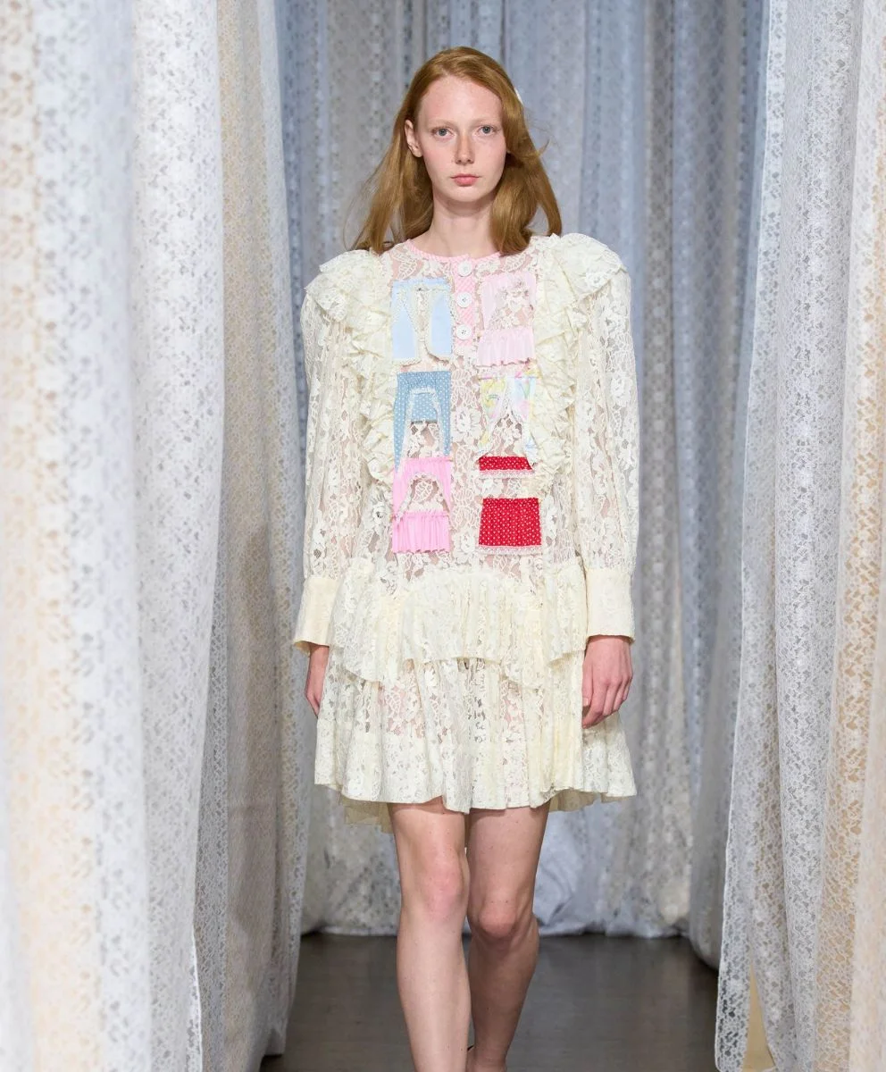 Model in Sandy Liang’s Spring Summer 2026 lace dress with dollhouse-inspired patchwork, highlighting childhood nostalgia explored by C2 Fashion Studio trend forecasting agency.