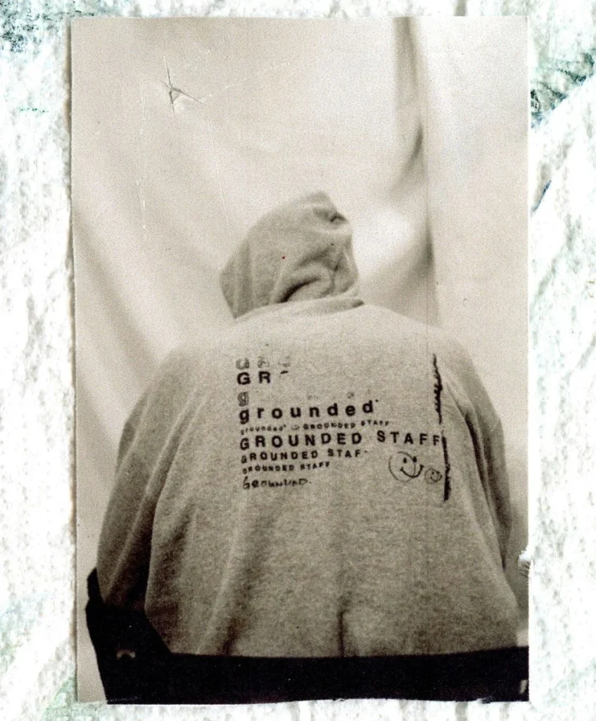 Back view of a hoodie with “Grounded Staff” typography, symbolizing emotional branding and cultural storytelling, featured in C2 Fashion Studio’s trend forecasting platform.