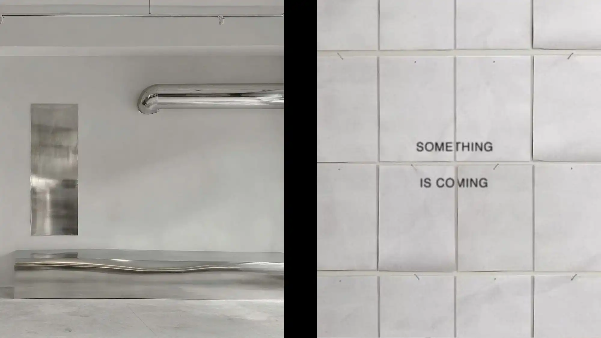 Minimalist metallic interior with reflective surfaces and a typographic art wall reading “Something is coming,” symbolizing C2 Fashion Studio’s visionary trend forecasting and anticipation of future fashion movements.