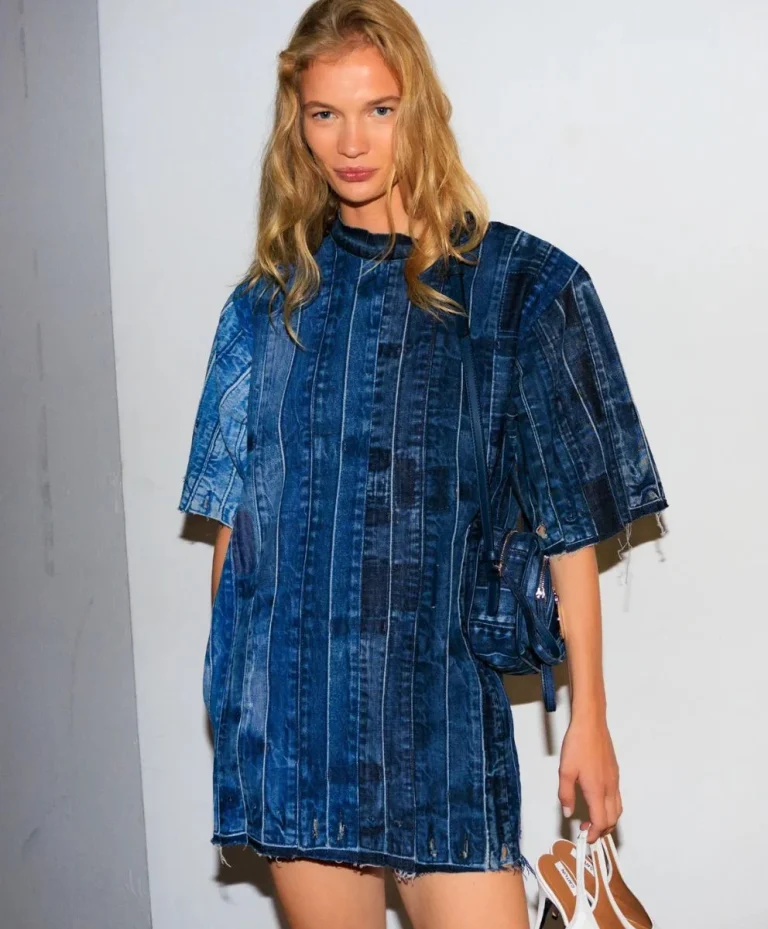 Model wearing a sustainable denim dress from Stella McCartney’s Pure.Tech Spring Summer 2026 collection, illustrating the concept of Active Sustainability and fashion trend forecasting focused on regenerative design.