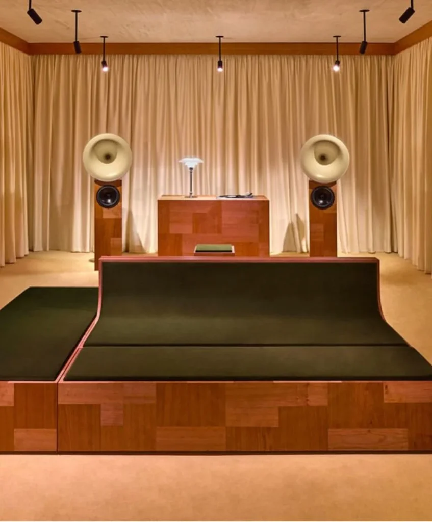 Luxury experiential retail interior featuring minimalist wooden furniture and high-end sound design, symbolizing the rise of emotional economy and sensory luxury explored by C2 Fashion Studio’s trend forecasting platform.
