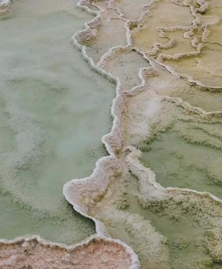 Aerial view of mineral formations in soft green and beige tones, inspiring Spring Summer 2028 color trend forecasting and C2’s Luminous Balance chromatic direction.