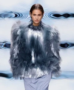 Model wearing metallic tactile-textured outfit in shades of blue and silver, representing Multisensory Experience — the C2 Fashion Studio trend forecast for Spring Summer 2027 focused on hyper-tactility and emotional design.