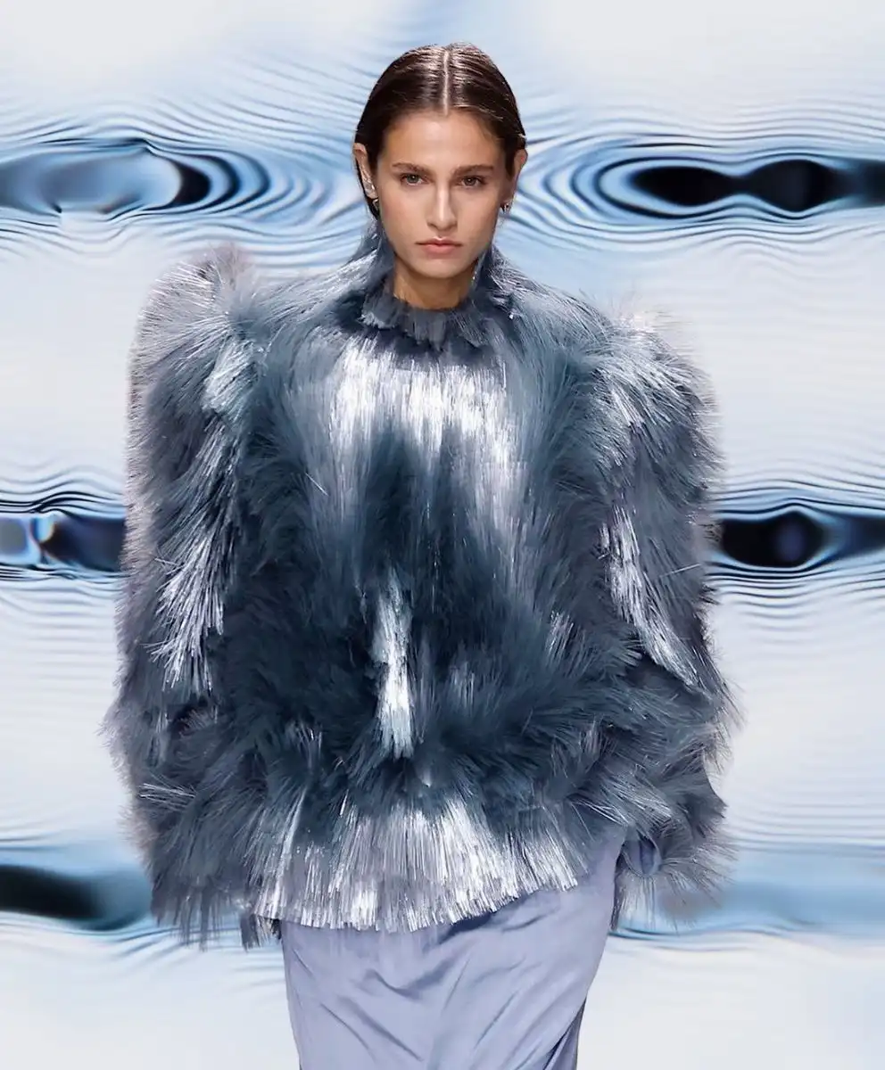 Model wearing metallic tactile-textured outfit in shades of blue and silver, representing Multisensory Experience — the C2 Fashion Studio trend forecast for Spring Summer 2027 focused on hyper-tactility and emotional design.