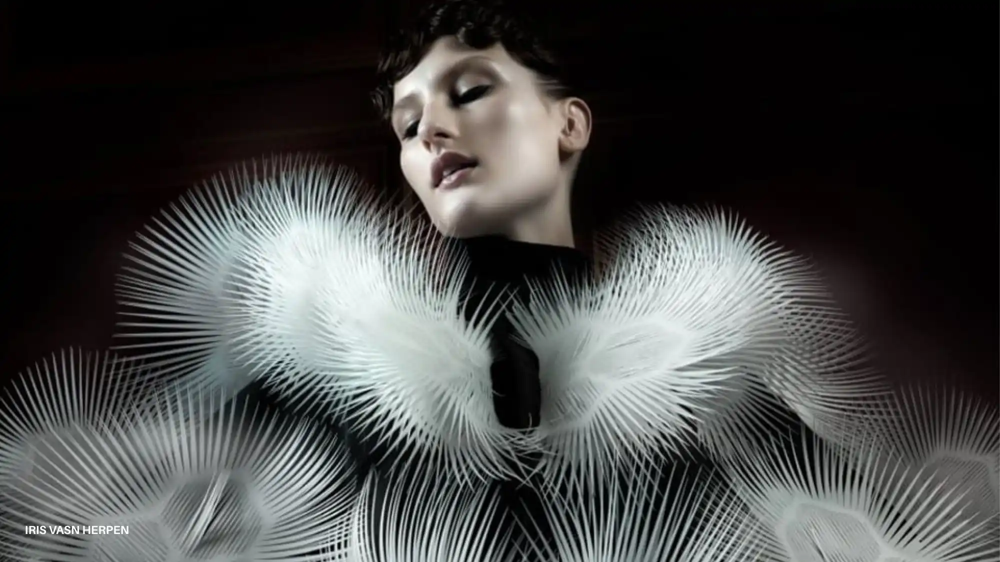 Model wearing an Iris van Herpen sculptural garment with dynamic, feather-like structures, symbolizing responsive materials and AW27/28 Material Luxury Intelligence trends.