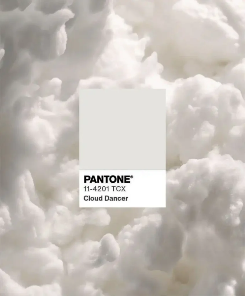 Pantone 11-4201 TCX Cloud Dancer swatch on a soft white cloud texture, representing the Pantone Color of the Year 2026 and its influence on future Color Trends and refined clarity in design.
