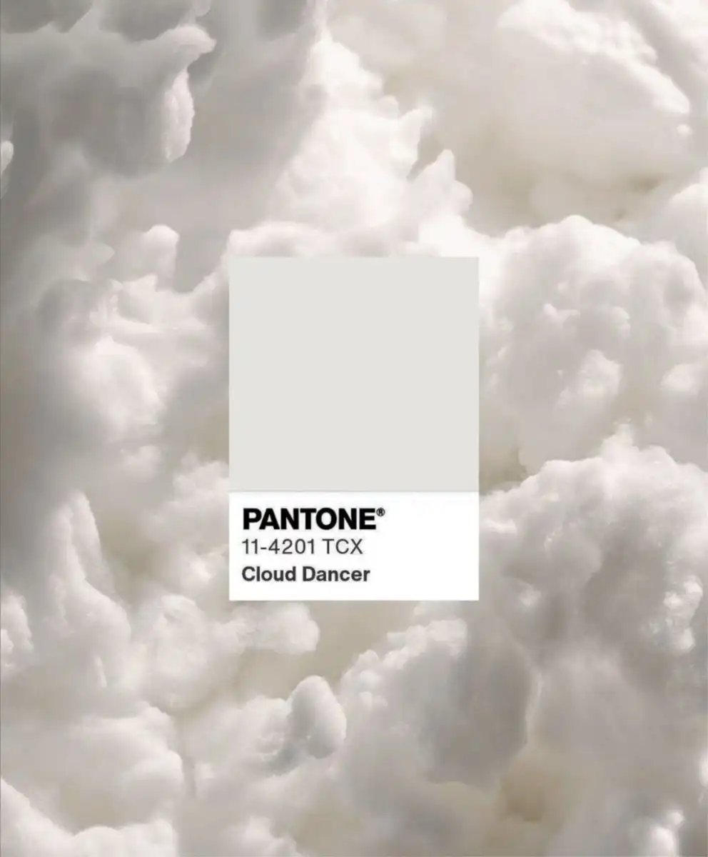 Pantone 11-4201 TCX Cloud Dancer swatch on a soft white cloud texture, representing the Pantone Color of the Year 2026 and its influence on future Color Trends and refined clarity in design.