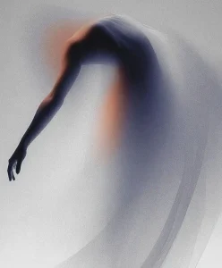 Ethereal blurred silhouette in soft gradient light illustrating the Sensory Minimalism Shift, a key Spring Summer 2028 Fashion Trend identified by C2 Fashion Studio’s Trend Forecasting research.