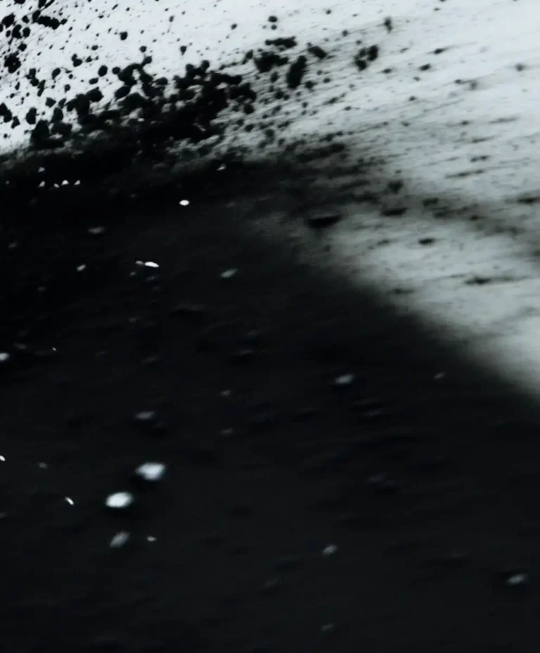 Abstract black-and-white material surface expressing material intelligence evolution, from static textures to active systems in AW27/28 fashion trend forecasting.