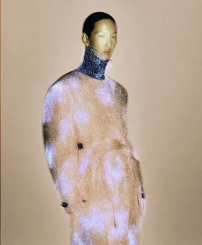 Model wearing a luminous, technology-inspired garment representing Digital Enlightenment, the key macro fashion trend for Spring Summer 2027.