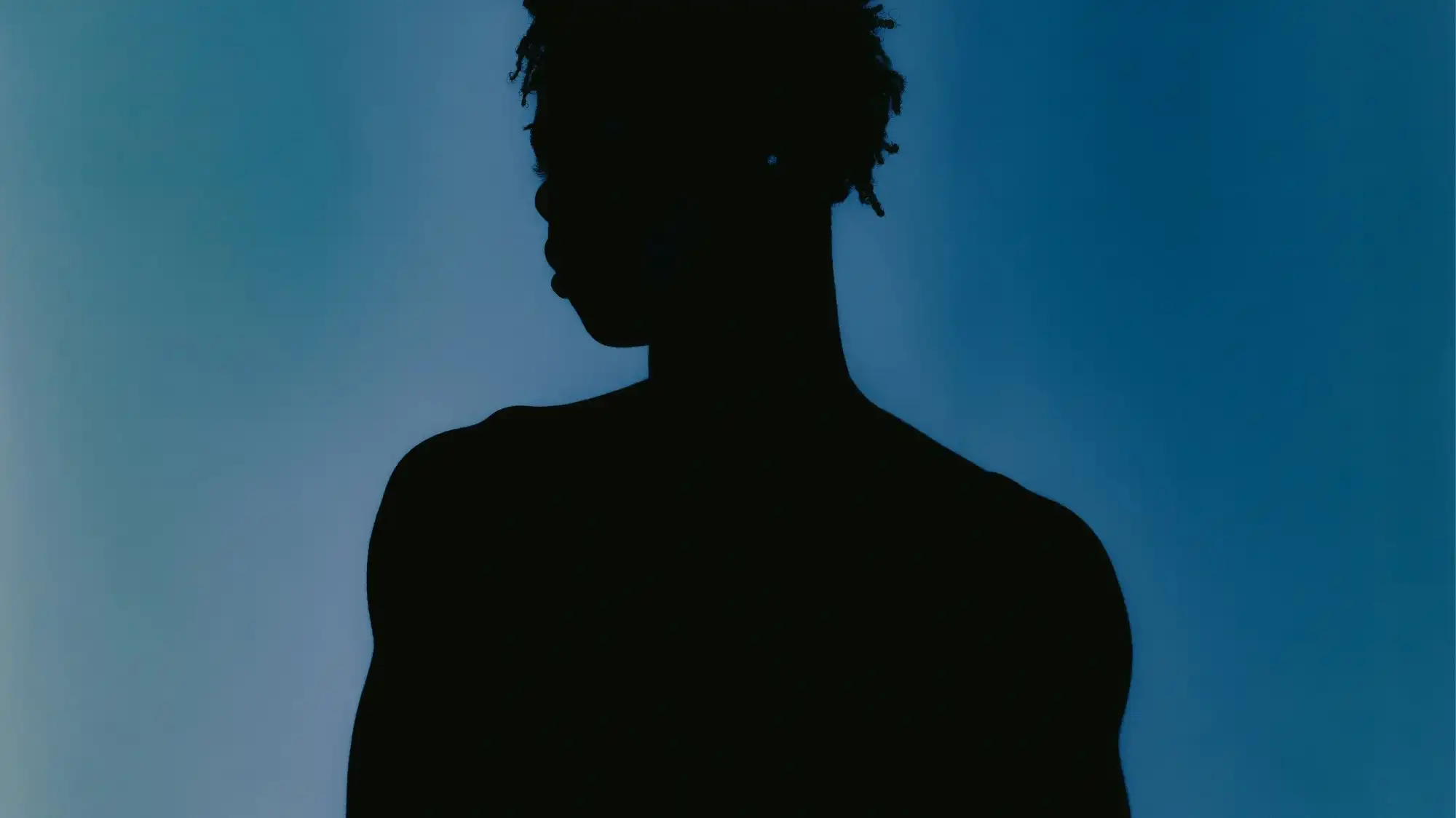 Minimal silhouette portrait in blue gradient light reflecting emotional depth in Fashion Trend Forecasting by C2 Fashion Studio Trend Forecasting.