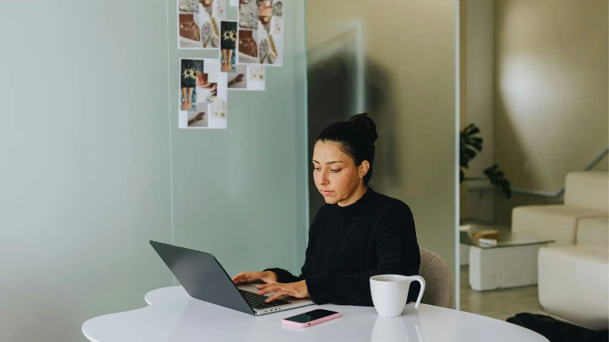 Fashion professional analyzing design references and trend research on laptop as part of Fashion Trend Forecasting by C2 Fashion Studio Trend Forecasting.