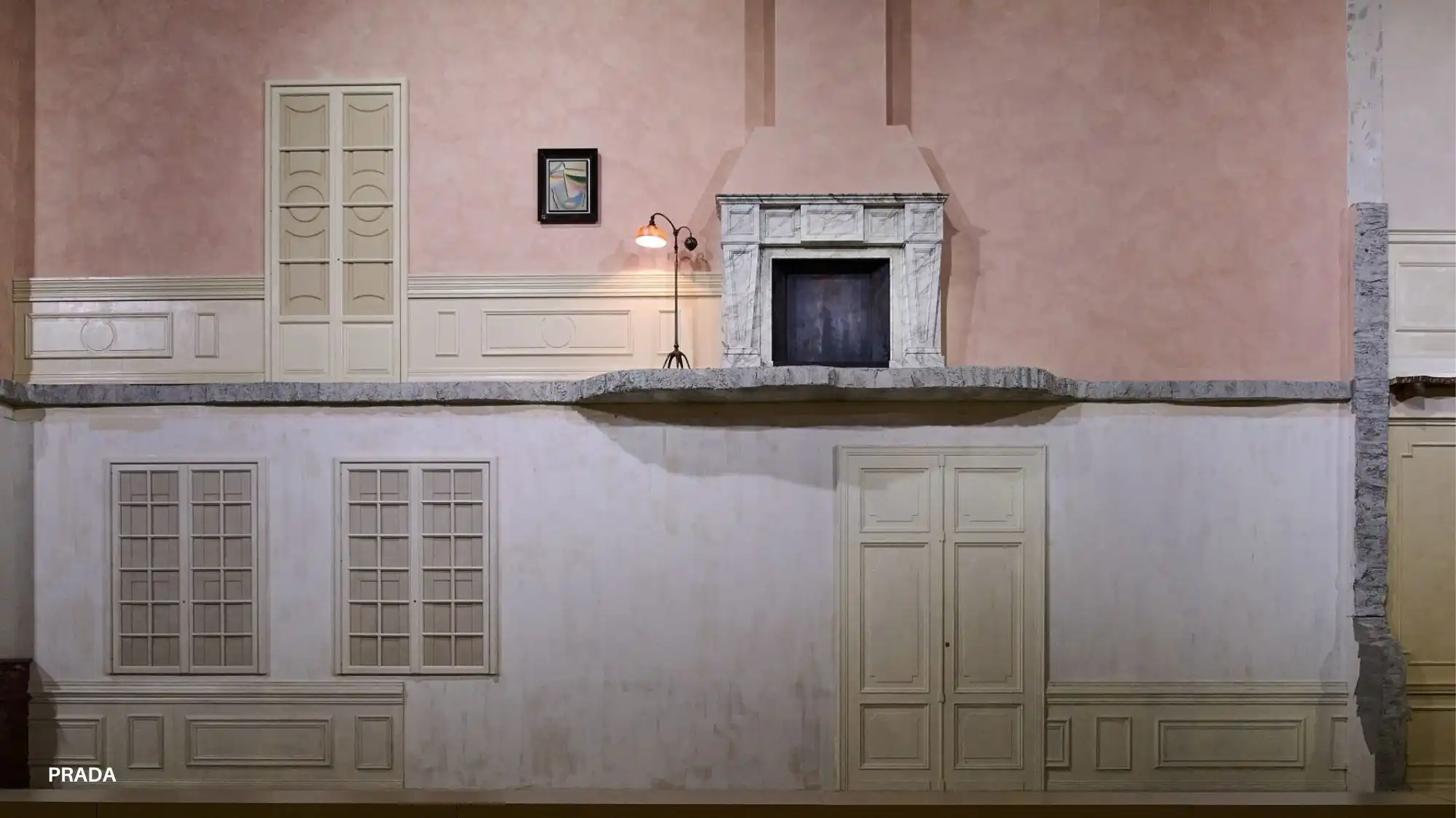 Prada Fall Winter 2026/27 runway set design featuring a theatrical domestic interior illustrating conceptual staging analyzed through Fashion Trend Forecasting by C2 Fashion Studio Trend Forecasting.