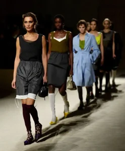 Prada Fall Winter 2026/27 runway models showcasing layered silhouettes and structured styling analyzed through Fashion Trend Forecasting and Trend Intelligence by C2 Fashion Studio Trend Forecasting.