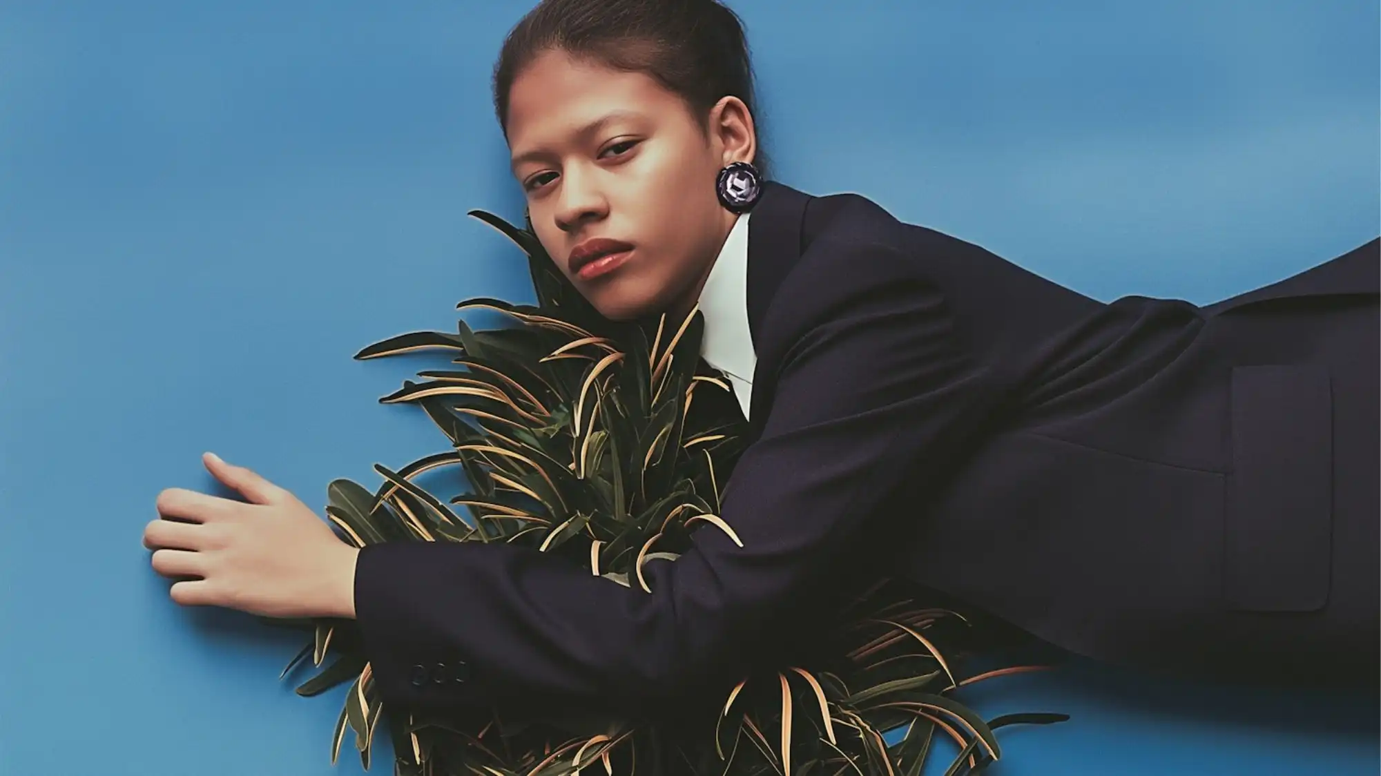 Future Consumer 2028 fashion portrait featuring structured tailoring, botanical elements, and sharp contemporary styling representing cultural intelligence, emotional resilience, and future luxury aesthetics by C2 Fashion Studio.
