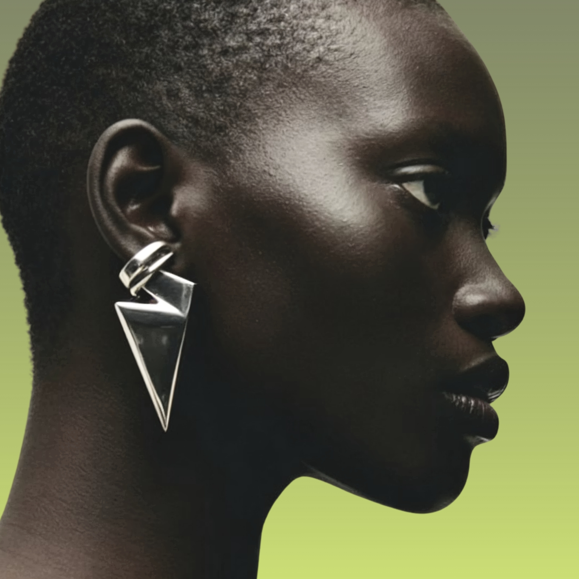 Minimal luxury fashion portrait featuring sculptural metallic jewelry and pointed black leather footwear, representing Clarity Intelligence, strategic Fashion Trend Forecasting, and refined contemporary luxury aesthetics by C2 Fashion Studio.