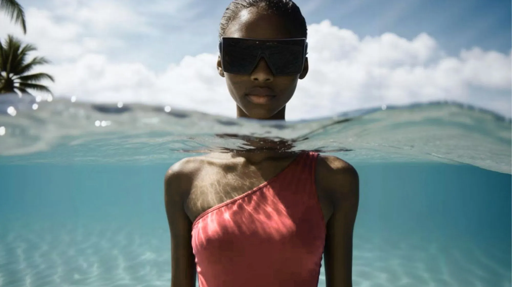 Spring Summer 2028 Beachwear Trends featuring a coral one-shoulder swimsuit and futuristic sunglasses. C2 Fashion Studio Fashion Trend Forecasting and Trend Intelligence.