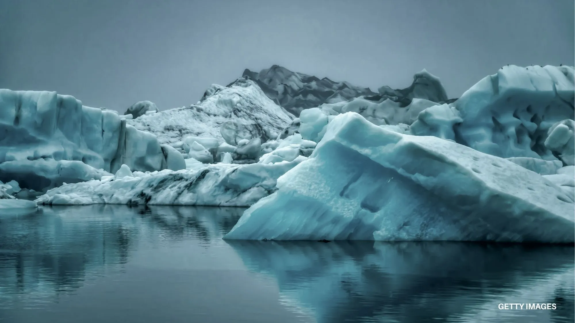 Climate adaptation towards 2036 by C2 Fashion Studio, featuring blue icebergs and glacial landscapes highlighting environmental change, climate resilience and future sustainability trends.
