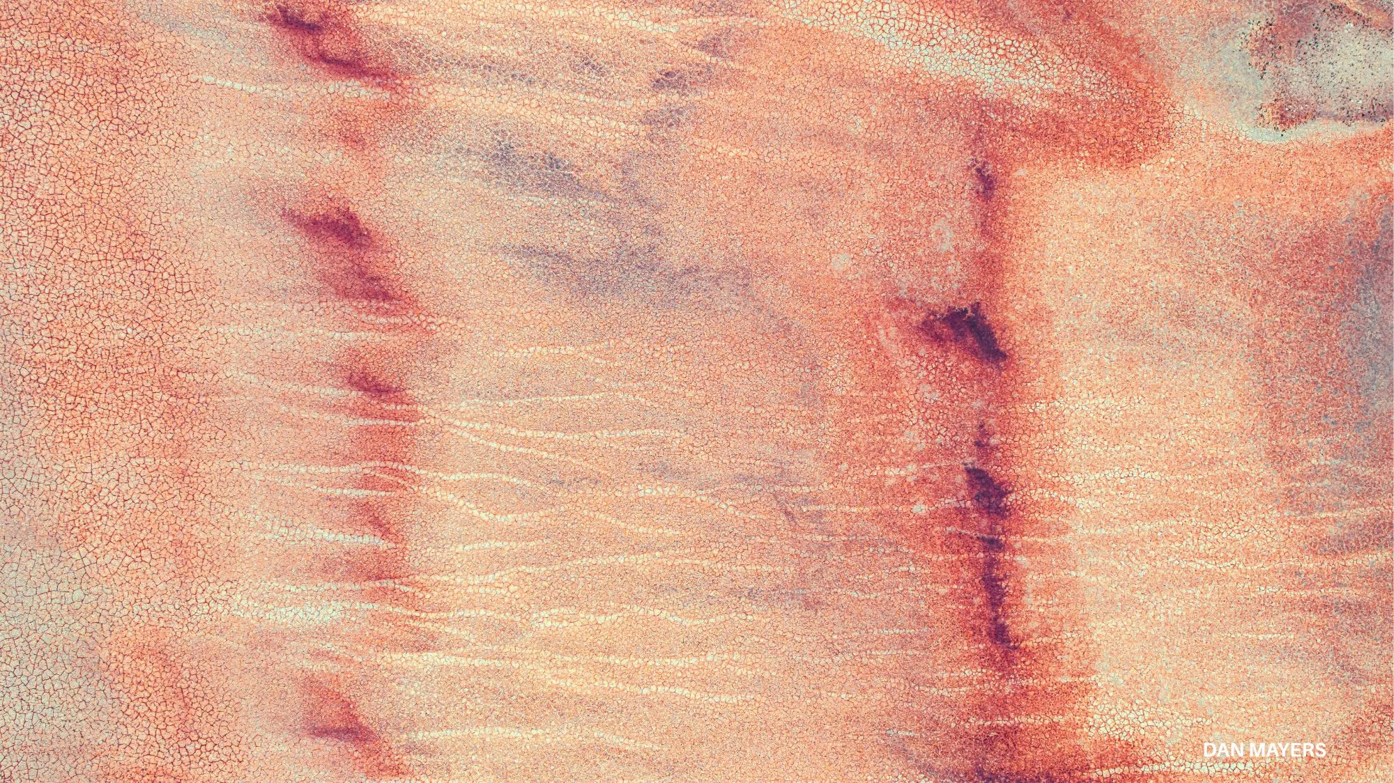 Climate adaptation towards 2036 by C2 Fashion Studio, featuring cracked, drought-affected earth in warm pink and terracotta tones, highlighting climate change, environmental transformation and future sustainability trends.
